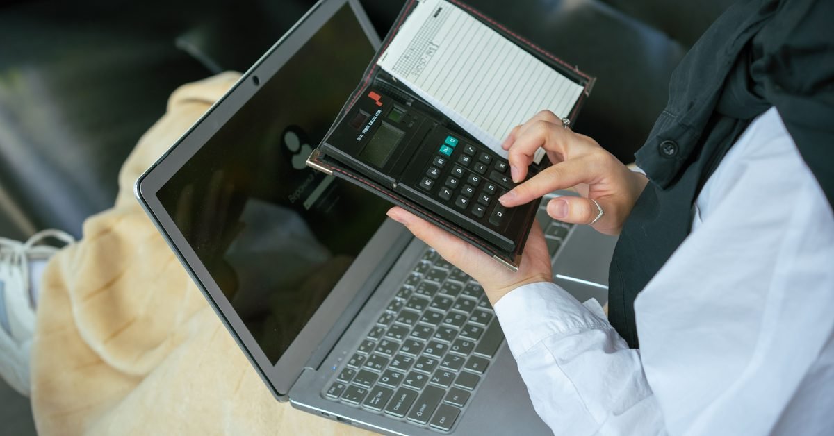Working through bootcamp financing options with a laptop and calculator